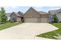 Inviting single story brick home with a manicured lawn and an attached three car garage at 11595 Platt St, Noblesville, IN 46060
