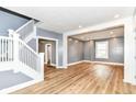 Spacious living room featuring hardwood floors, staircase, and neutral paint, perfect for entertaining at 1234 N Dearborn St, Indianapolis, IN 46201