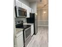 Updated kitchen featuring stainless appliances, granite counters, and open floorplan at 12873 Tradd St # 2B, Carmel, IN 46032
