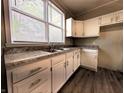 A close up view of the kitchen's new cabinets, countertops and large window at 1303 9Th St, Columbus, IN 47201