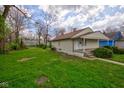 Cozy home with an expansive, lush green yard and a quaint, inviting exterior at 1467 W 33Rd St, Indianapolis, IN 46208