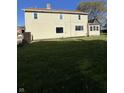 Expansive backyard with sunny lawn and view of the home's rear exterior at 1641 English Ave, Indianapolis, IN 46201