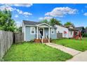 Beautiful light blue home with a nice yard; featuring a porch, sidewalk and well maintained grass at 1641 Iowa St, Indianapolis, IN 46203