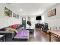 Open-concept living room with modern finishes, sleek furniture, wood floors, and a large television at 1641 Iowa St, Indianapolis, IN 46203