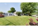 Spacious backyard featuring lush lawn, mature trees, and fenced-in area with additional garage at 1855 Cruft St, Indianapolis, IN 46203