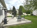 Stone patio with outdoor seating, including a pergola and chairs, perfect for outdoor relaxation at 18680 Long Walk Ln, Noblesville, IN 46060