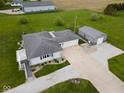 Aerial view of a home with a large yard and detached garage at 1970 E 1100 N, Alexandria, IN 46001