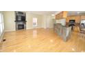 Spacious living room with hardwood floors, stone fireplace, and open kitchen access at 2363 N Pennsylvania St, Indianapolis, IN 46205