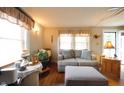 Comfortable living room with a plush couch, ottoman, and natural light streaming in through the windows at 2657 Mars Hill St, Indianapolis, IN 46241
