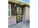 Close up of the front door with security gate and brick exterior at 2842 Sangster Ave, Indianapolis, IN 46218