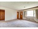 Spacious living room with natural light, carpet, and original features at 2842 Sangster Ave, Indianapolis, IN 46218