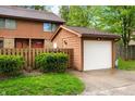 This townhome features a detached one-car garage and attractive landscaping at 3165 Sycamore Dr, Columbus, IN 47203