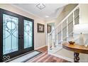 Inviting entryway features a glass front door, hardwood floors, a staircase, and neutral paint at 3444 Briar Pl, Carmel, IN 46033