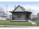 Charming gray home featuring a covered front porch and well-maintained lawn at 3845 Cornelius Ave, Indianapolis, IN 46208