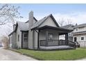 Well-maintained home with a covered front porch and a chimney on the side at 3845 Cornelius Ave, Indianapolis, IN 46208