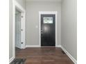 View of the entryway, featuring a black door with decorative glass, modern trim, and hardwood floors at 400 N Sycamore St, Martinsville, IN 46151
