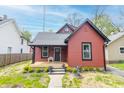 Charming red bungalow with black trim, a grey roof, small porch, and freshly cut lawn at 400 N Sycamore St, Martinsville, IN 46151