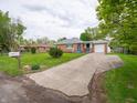 Traditional brick ranch-style home with a paved driveway and a well-maintained front lawn at 4029 N Euclid Ave, Indianapolis, IN 46226