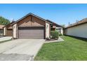 A house showing the garage and well-maintained front yard with green grass at 4107 Zinfandel Way, Indianapolis, IN 46254