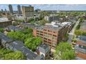 Building exterior, showing its place within a neighborhood setting with mature trees and proximity to downtown at 430 N Park Ave # 103, Indianapolis, IN 46202