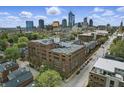 Stunning aerial view of the building with a city skyline backdrop on a partly cloudy day at 430 N Park Ave # 103, Indianapolis, IN 46202