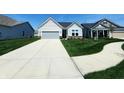 Beautiful single-story home showcasing a long driveway and lush front lawn at 4734 Cleome Dr, Plainfield, IN 46168