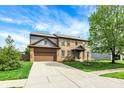 Traditional brick home with a well-kept lawn, two-car garage, and inviting curb appeal at 48 E Wisteria Way, Westfield, IN 46074