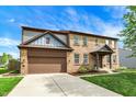 Attractive brick home with two-car garage, covered front porch, and neat landscaping at 48 E Wisteria Way, Westfield, IN 46074