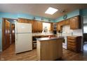 Traditional kitchen featuring wood cabinets, an island, and white appliances at 5041 Norcroft Dr, Indianapolis, IN 46221