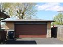 Spacious detached two car garage with brick facade and a brown garage door at 518 Cherry St, Beech Grove, IN 46107