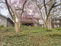 Two-story brick home surrounded by mature trees and lush landscaping at 5181 E Pleasant Run Pkwy S Dr, Indianapolis, IN 46219