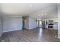 Spacious living area featuring modern gray walls, hardwood flooring, and stainless steel appliances at 5515 W Morris St, Indianapolis, IN 46241