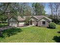 Inviting single-story home with attached two-car garage and a large front yard at 601 Shady Ln, Greenwood, IN 46142