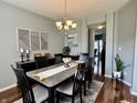Elegant dining room featuring a stylish chandelier, modern decor, and plenty of natural light at 6360 E Chapel Hill Ct, Camby, IN 46113