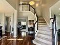 Grand foyer with hardwood floors, staircase, and views into the living room, creating an inviting entrance at 6360 E Chapel Hill Ct, Camby, IN 46113