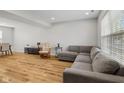 Bright living room with new wood floors, featuring a gray sofa, rocking chair, and natural light at 7163 Cordova Dr, Indianapolis, IN 46221