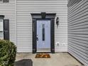 Close-up of a stylish light blue front door with black trim and house number displayed, plus autumn-themed welcome mat at 7202 Red Lake Ct, Indianapolis, IN 46217