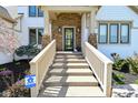 Inviting front porch with stone pillars, a decorative wreath, and a secure Pro Security sign at 728 Christin Ct, Plainfield, IN 46168