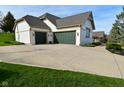 Spacious three-car garage with green doors, a wide driveway, and a basketball hoop at 728 Christin Ct, Plainfield, IN 46168