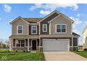 Two-story home featuring a white garage door, brown siding and coordinated stonework on the facade at 7417 Waylon Way, Indianapolis, IN 46239