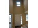 Bright foyer with tall ceilings, a front door with sidelight, and transom window at 7522 Timberfield Ln, Indianapolis, IN 46259