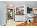 Inviting tiled foyer with an open view to the kitchen, hardwood floors, and ample natural light at 7856 Trotwood Cir, Indianapolis, IN 46256