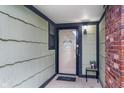 A cozy front porch with a decorative wreath and ample space for a welcome mat and potted plants at 7856 Trotwood Cir, Indianapolis, IN 46256