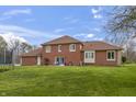 Large backyard featuring a well-kept lawn, trampoline, and access to the home at 8031 Edgewood Ct, Plainfield, IN 46168