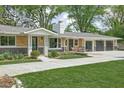 Charming ranch home with brick exterior, manicured lawn, and concrete driveway at 846 W 56Th St, Indianapolis, IN 46228