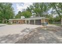 Ranch home featuring attached garage and updated driveway and landscape design at 846 W 56Th St, Indianapolis, IN 46228