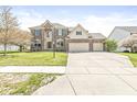 Traditional two-story brick home with a spacious driveway and well-maintained landscaping at 9037 Carnation Dr, Noblesville, IN 46060