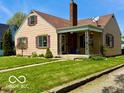 Traditional single-Gathering home featuring a chimney and a covered front porch at 908 E 32Nd St, Anderson, IN 46016