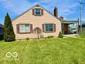 Lovely single-Gathering home with a lush green lawn and a welcoming covered front porch at 908 E 32Nd St, Anderson, IN 46016