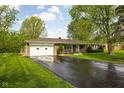Exterior view of home showcasing brick facade, attached garage, and driveway at 9303 Leroy Rd, Brownsburg, IN 46112